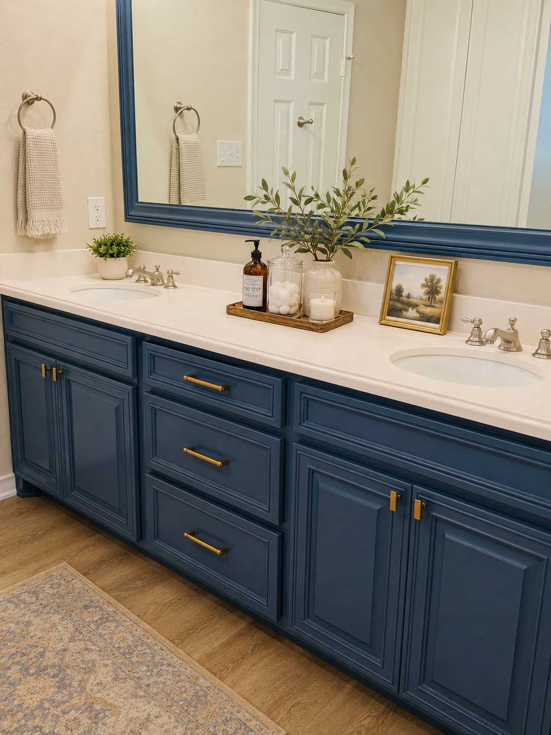 Navy blue painted double bathroom vanity with gold hardware and painted mirror frame in North Dallas