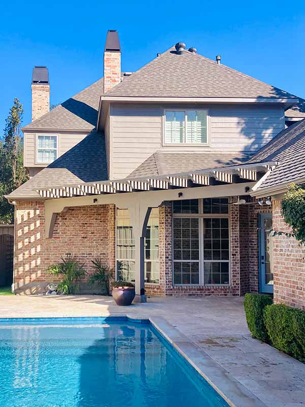Exterior painted two-story home with pergola, painted trim, and pool in North Dallas backyard