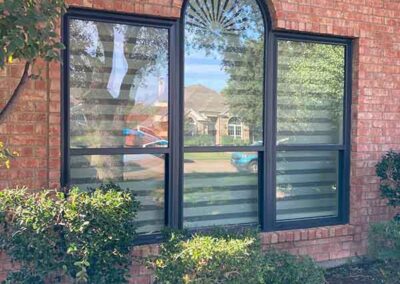 exterior painting dark window frames arched center window decorative detail brick exterior