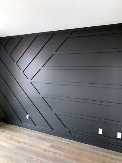 Painted black geometric trim accent wall with herringbone pattern in North Dallas home
