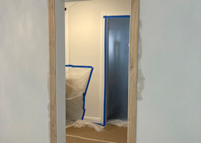 trim painting doorway bare wood trim blue tape surface protection walls masked