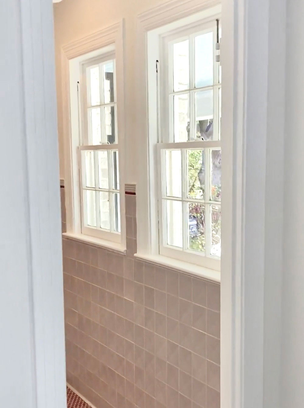 Freshly painted white window trim and casing in North Dallas bathroom with tile wainscoting